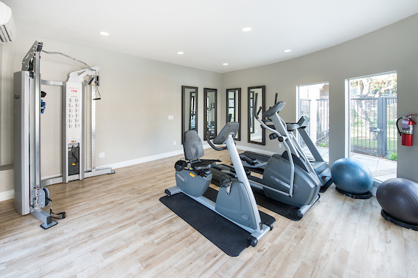 Fitness center with cardio and strength training equipment.