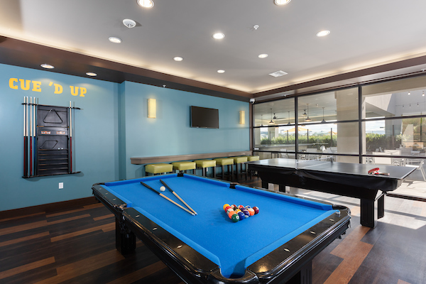 Club room with pool table, TV, and ping pong table.