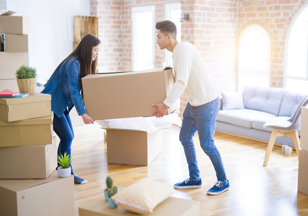 Couple in an apartment with moving boxes. 