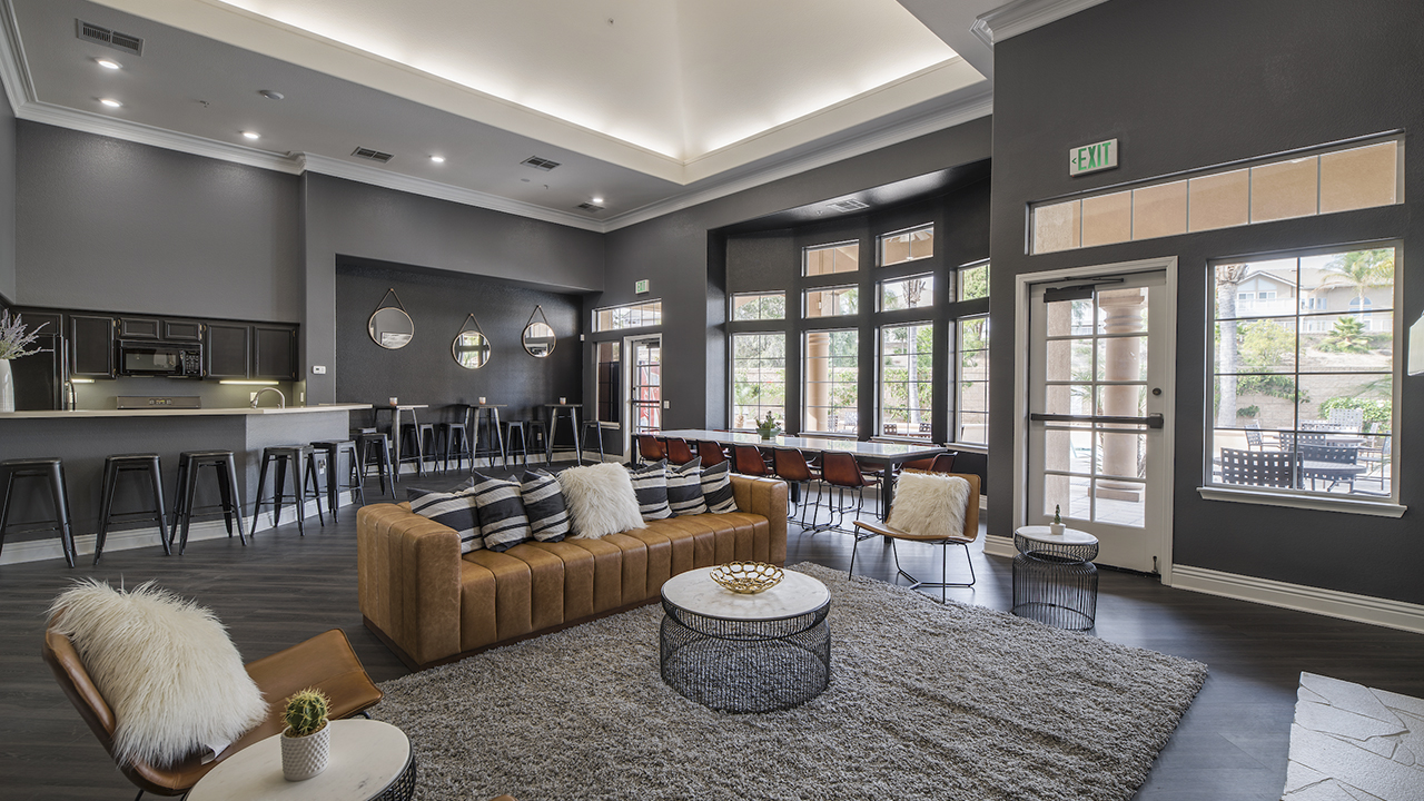 Cozy Clubhouse with a sofa, lounge chairs, a breakfast bar, and bar seating