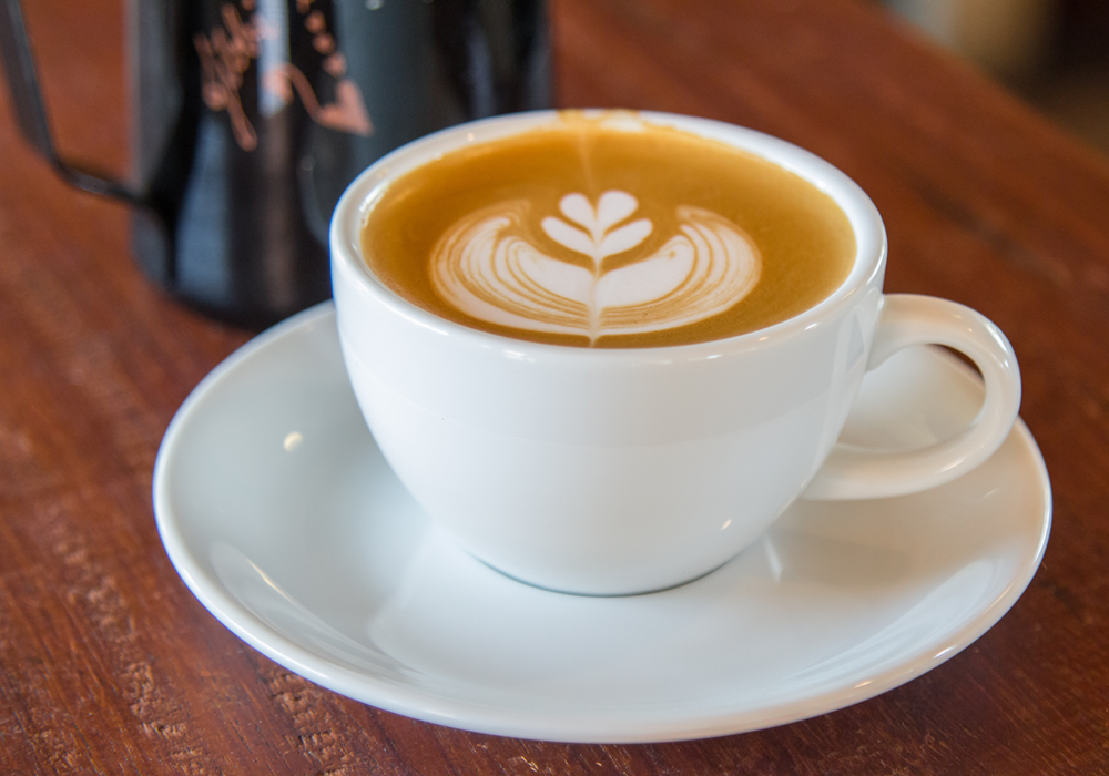 A cup of coffee with latte art design.