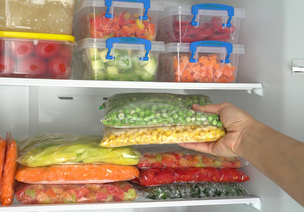 Meal prep vegetables stored in an apartment fridge.