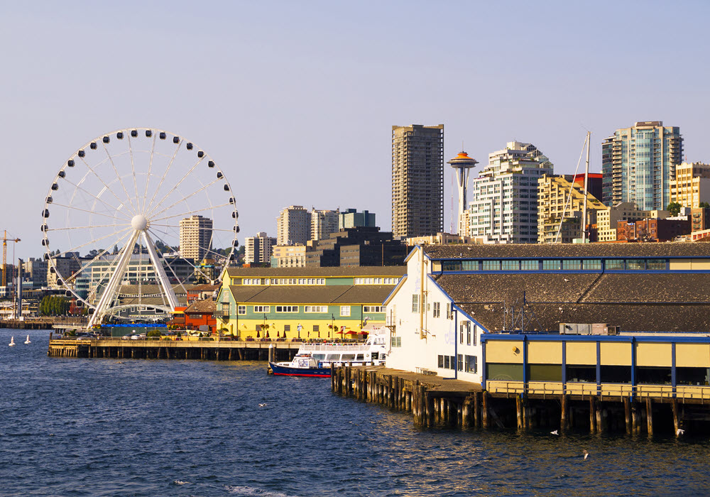 A Seattle pier at dusk featuring a Ferris wheel.
