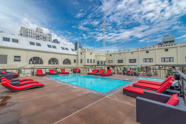 Outdoor swimming pool area with lounge seating.