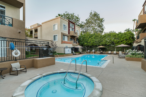 Outdoor spa and swimming pool area with lounge seating.