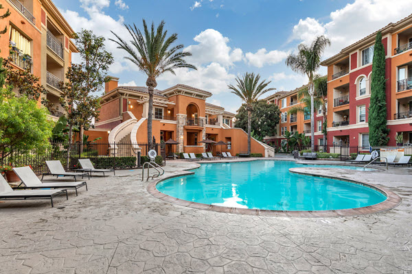 Outdoor swimming pool area with lounge seating.