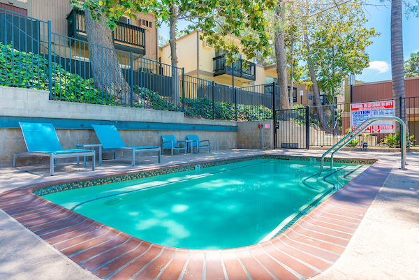 Outdoor swimming pool area with lounge seating.