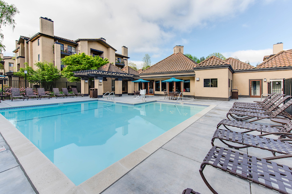 Outdoor swimming pool area with lounge seating.