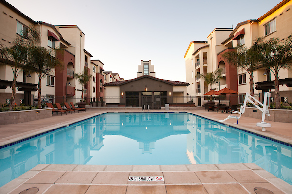 Outdoor swimming pool area with lounge seating.
